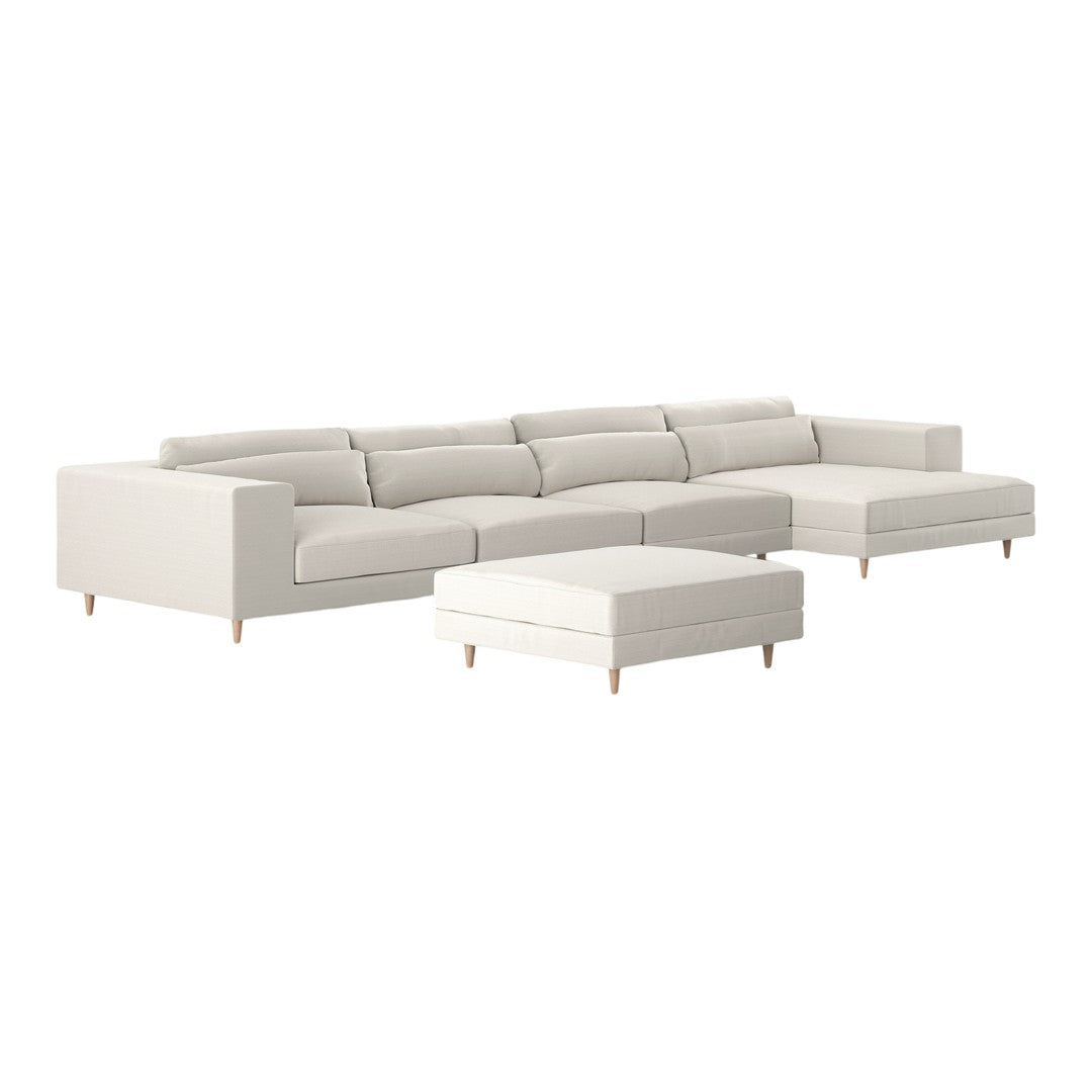 Light beige sectional sofa with clean lines and a minimalist design, featuring matching ottoman and wooden legs.