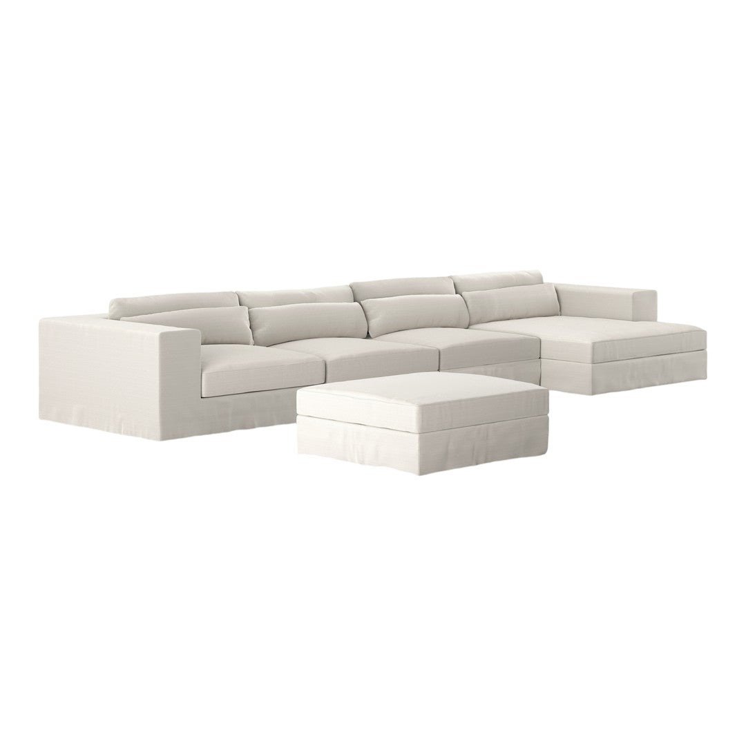 White sectional sofa with clean lines and soft cushions, complemented by a matching ottoman. Elegant and modern design.