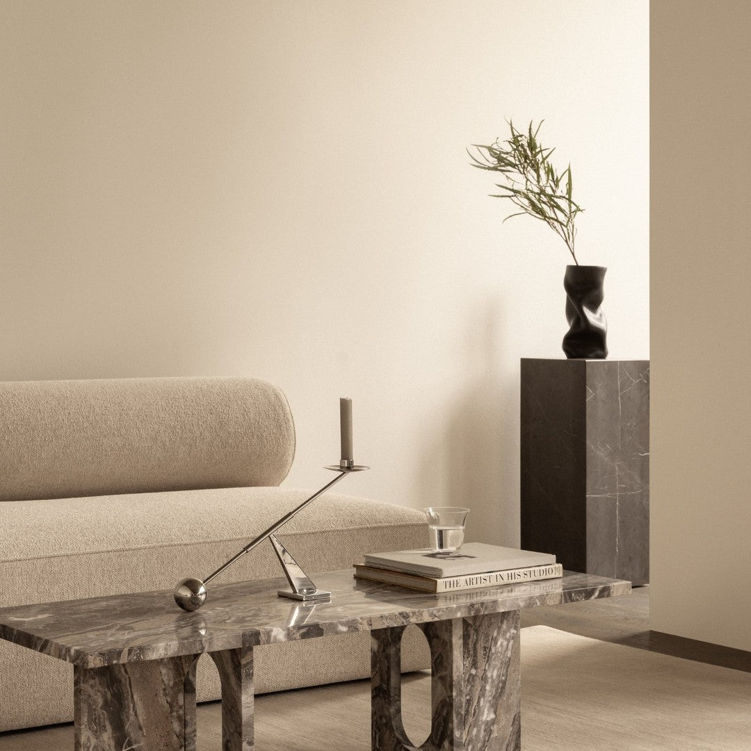 Neutral beige tones blend with textured marble patterns, creating a modern, minimalist aesthetic in the living space.