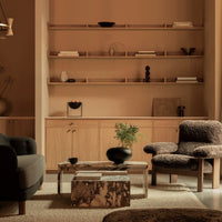 "Modern living room with earthy tones, textured gray upholstery, and natural wood accents."