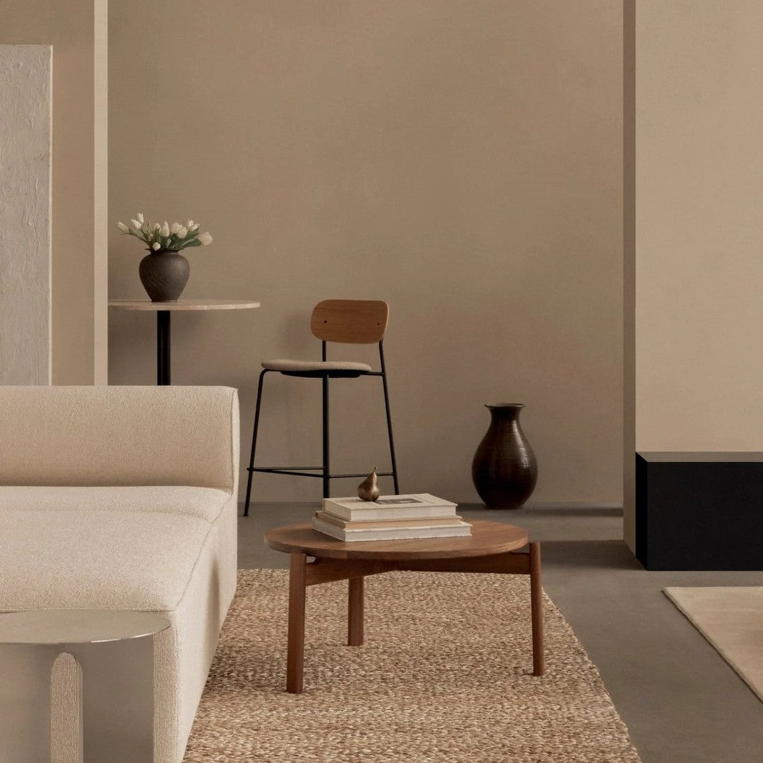 Neutral-toned living room featuring soft beige sofa, natural wood table, and earthy textures in a warm, minimalist design.