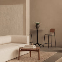 Modern living room featuring neutral tones, textured walls, and minimalist furniture in soft beige and warm earth colors.