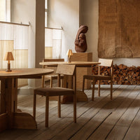 Natural wood tones with warm beige accents and a textured wall art piece in a minimalist interior setting.