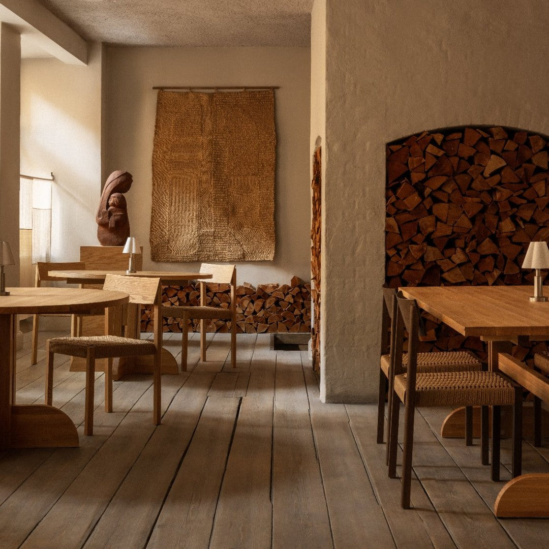 Warm wooden tones paired with neutral walls and textured wall art create a cozy, natural ambiance.