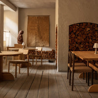 Warm wooden tones paired with neutral walls and textured wall art create a cozy, natural ambiance.
