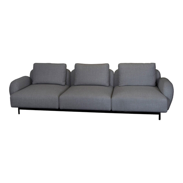 Gray upholstered sofa with smooth, subtle texture and clean lines, featuring three wide seats and a minimalist style.