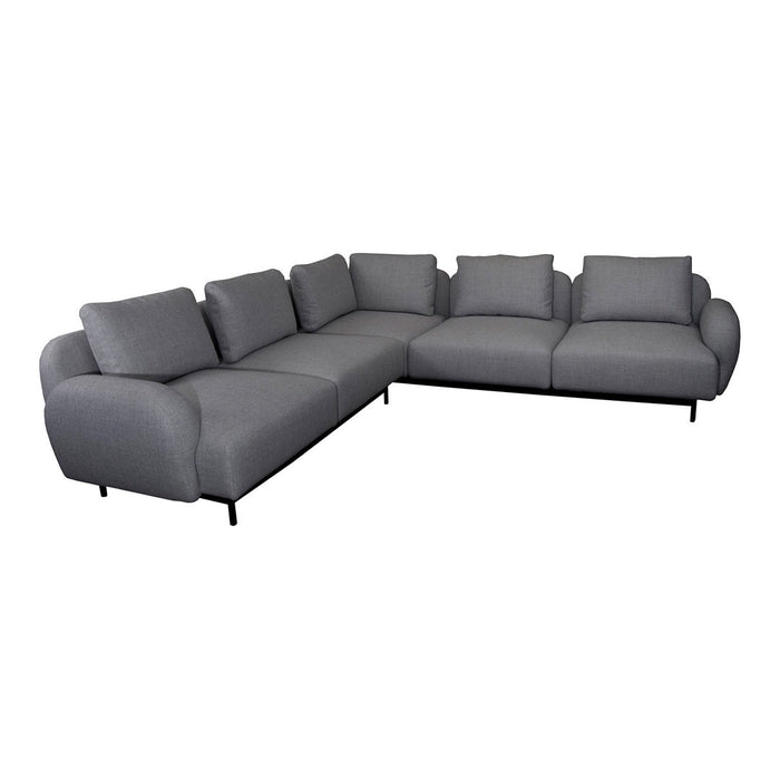 Gray sectional sofa with smooth fabric and contemporary curved edges, perfect for modern living spaces.