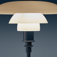 Modern lamp featuring layered white and cream shades with a sleek black base, perfect for contemporary decor.