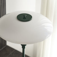 White glass lamp shade with a smooth, glossy finish and a dark green accent at the top.