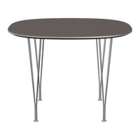 Round grey tabletop with sleek silver metal legs, perfect for modern dining spaces.