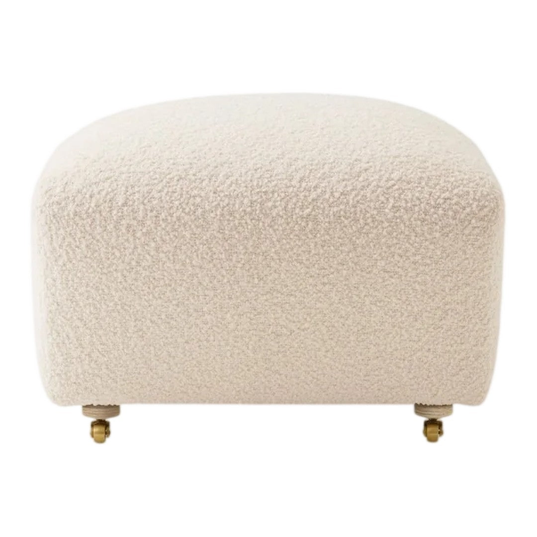 Beige textured ottoman with a soft, fluffy surface and gold-plated feet, perfect for modern decor.