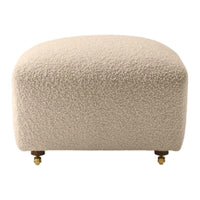 Beige boucle ottoman with a textured surface and gold caster legs, perfect for modern decor.