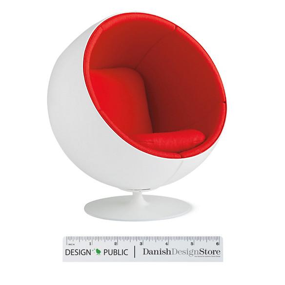 Red and white modern chair with a smooth, spherical design and plush seating. Perfect for contemporary decor.
