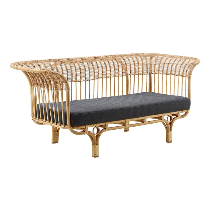 Rattan sofa with natural bamboo finish and a dark gray cushion, featuring a sleek, woven pattern.