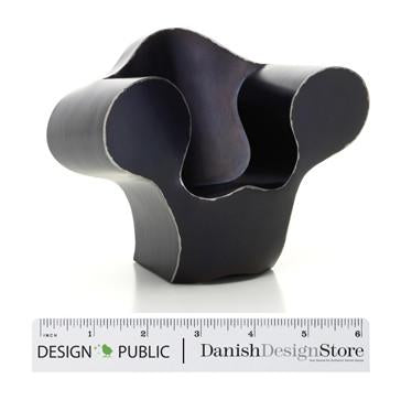 Modern black chair with smooth curves and a sleek silhouette against a white background. Unique, minimalist design.