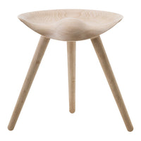 Light wooden stool with a smooth, curved seat and tapered legs, featuring a natural finish and minimalist design.