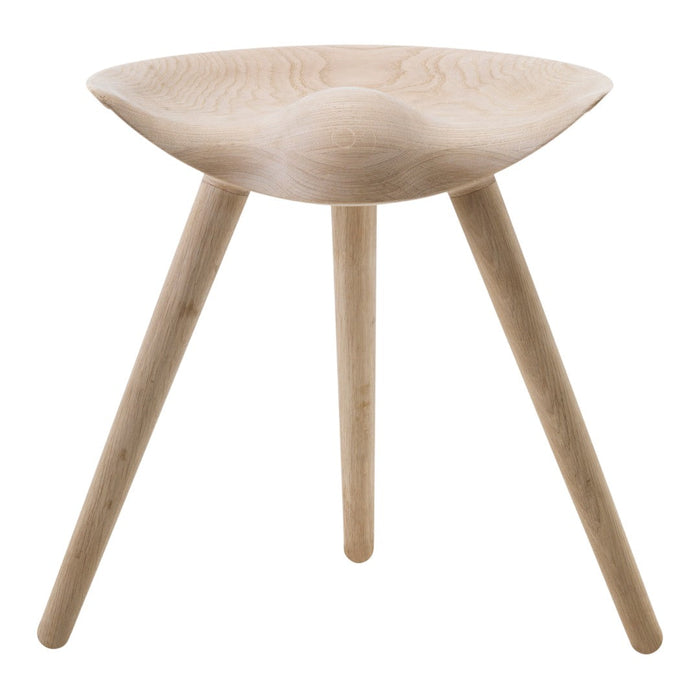 Light wooden stool with a smooth, curved seat and tapered legs, featuring a natural finish and minimalist design.