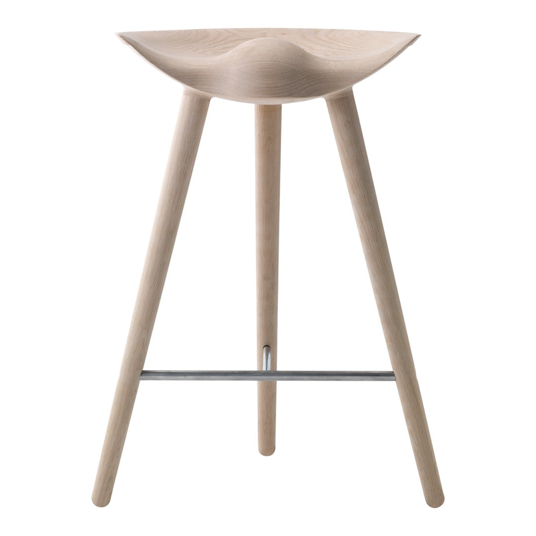 Natural wood bar stool with a smooth, curved seat and slender legs, showcasing a minimalistic design in light tones.