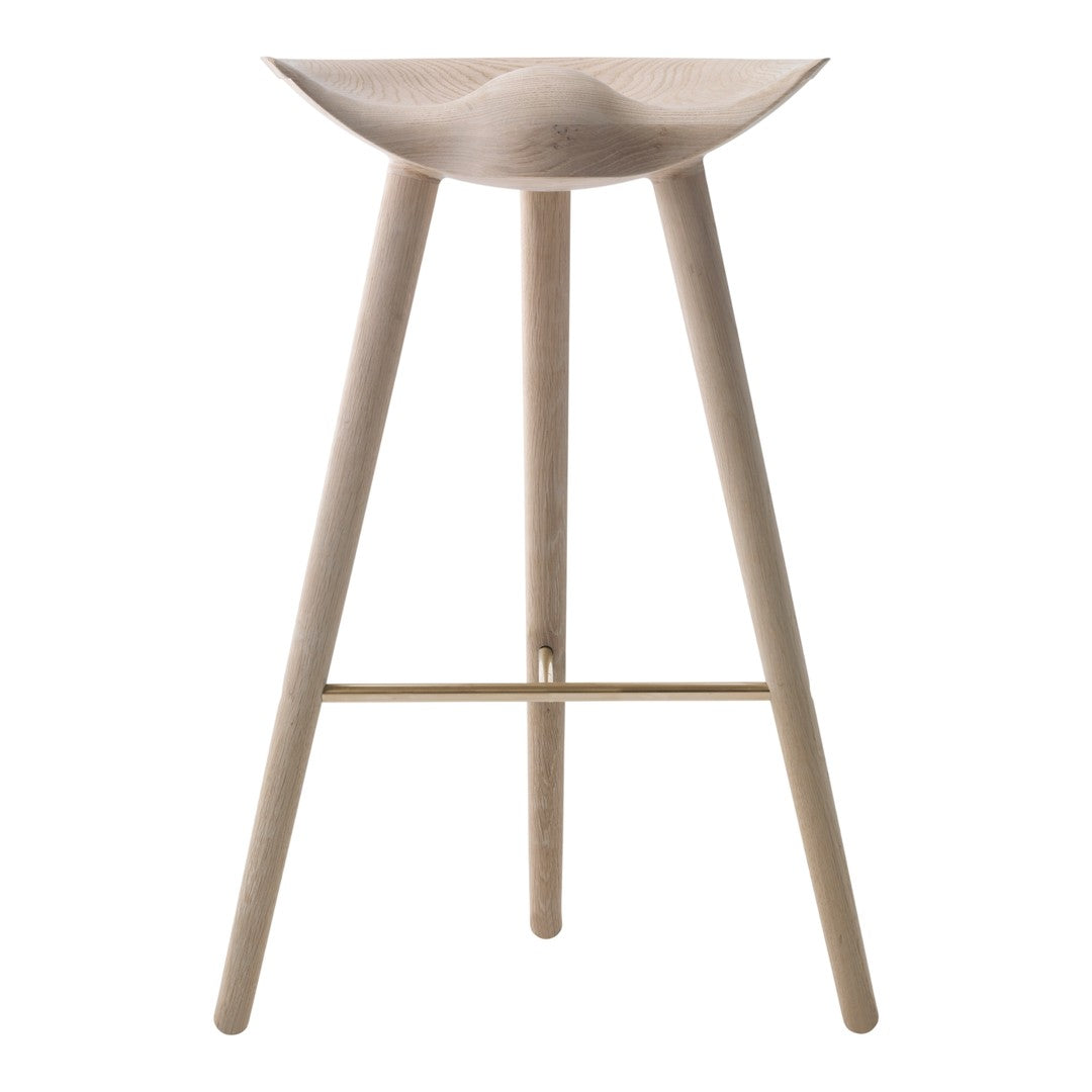 Light wood bar stool with a smooth curved seat and minimalist design, complemented by slender legs and a subtle gold accent.