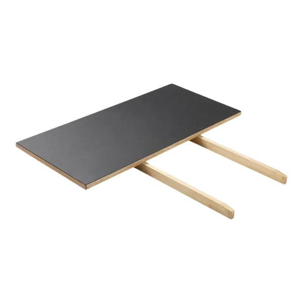 Black tabletop with light wooden legs, featuring a sleek, minimalist design. Ideal for modern interiors.
