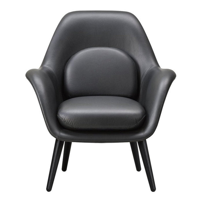 Black leather armchair with smooth, modern design and minimalist aesthetic, featuring tapered wooden legs.