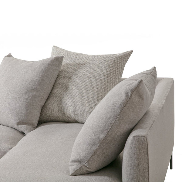 Light gray sofa with textured cushions, featuring a modern, minimalist design for stylish interiors.