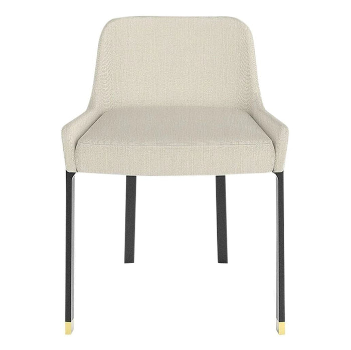Beige upholstered chair with black metal legs and gold accents, featuring a subtle textured pattern.