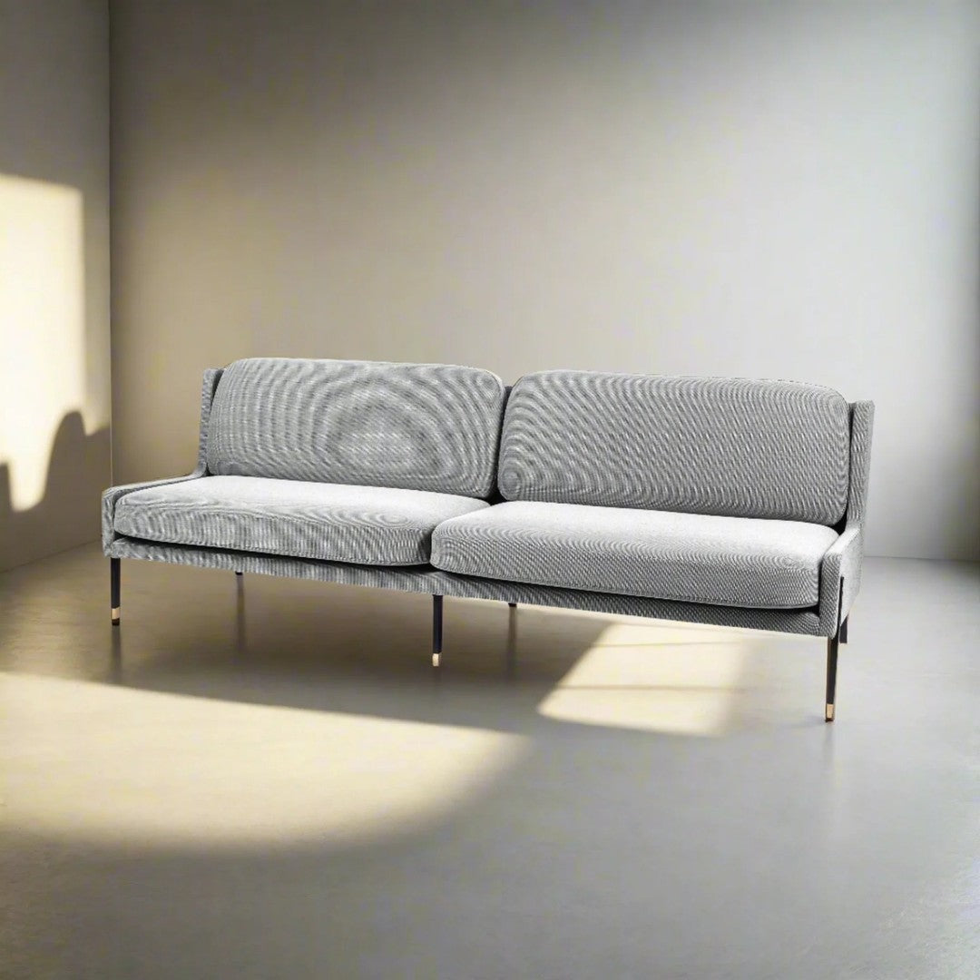 Modern gray sofa with a textured fabric pattern and sleek metal legs, perfect for contemporary living spaces.