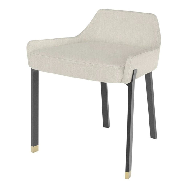 Cream upholstered chair with sleek black legs and gold accents, featuring a modern minimalistic design.