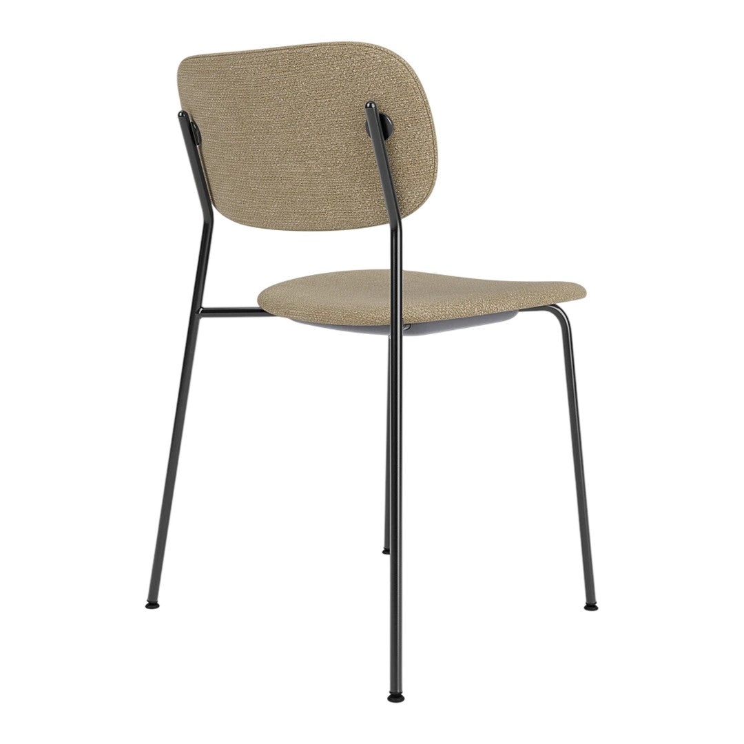 Neutral beige chair with a smooth texture and minimalistic black metal legs, featuring a simple and modern design.