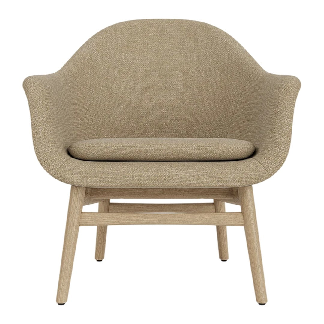 Beige upholstered chair with a smooth, rounded silhouette and wooden legs, perfect for modern decor.