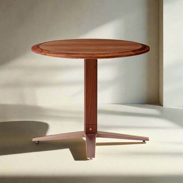 Round wooden table with rich walnut finish and sleek, minimalist design. Soft beige background enhances its elegance.