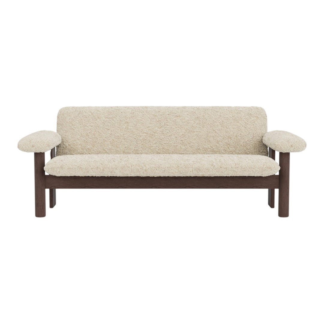 Beige upholstered sofa with a textured pattern and wooden frame, featuring rounded armrests for a cozy look.