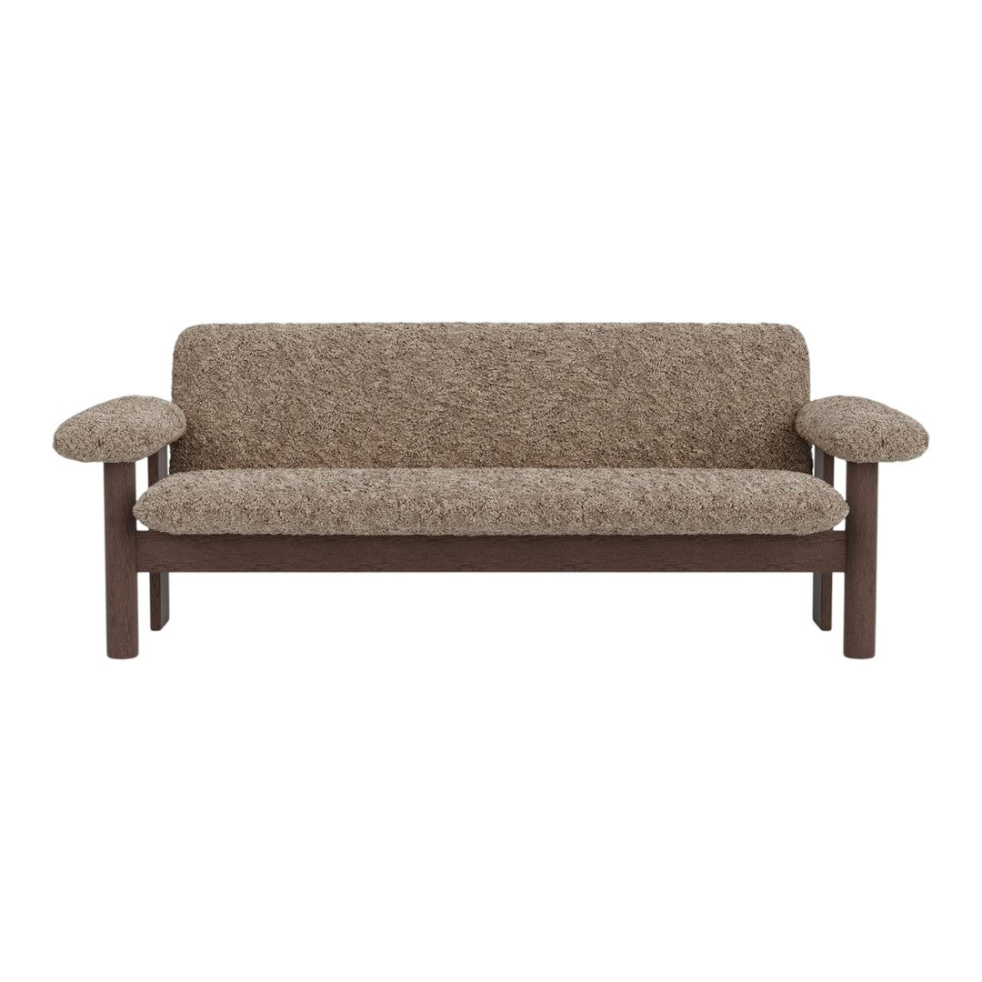 Textured brown fabric sofa with rounded armrests and dark wood frame, showcasing a cozy, neutral palette.
