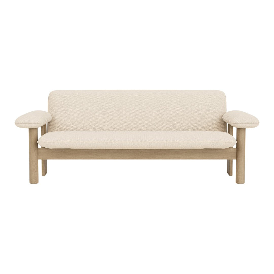 Beige upholstered sofa with light wood arms and base, featuring a minimalist design and smooth surfaces.