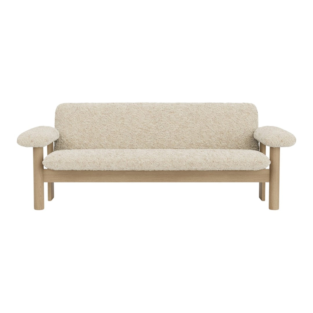 Beige-textured sofa with light wood arms, featuring a minimalist design and soft, neutral tones.