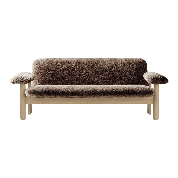 Elegant brown plush sofa with a textured fabric design and light wood legs, perfect for cozy interiors.