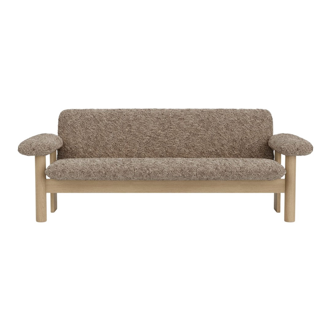 Brown textured fabric sofa with rounded armrests and a light wood frame, showcasing a cozy, contemporary design.