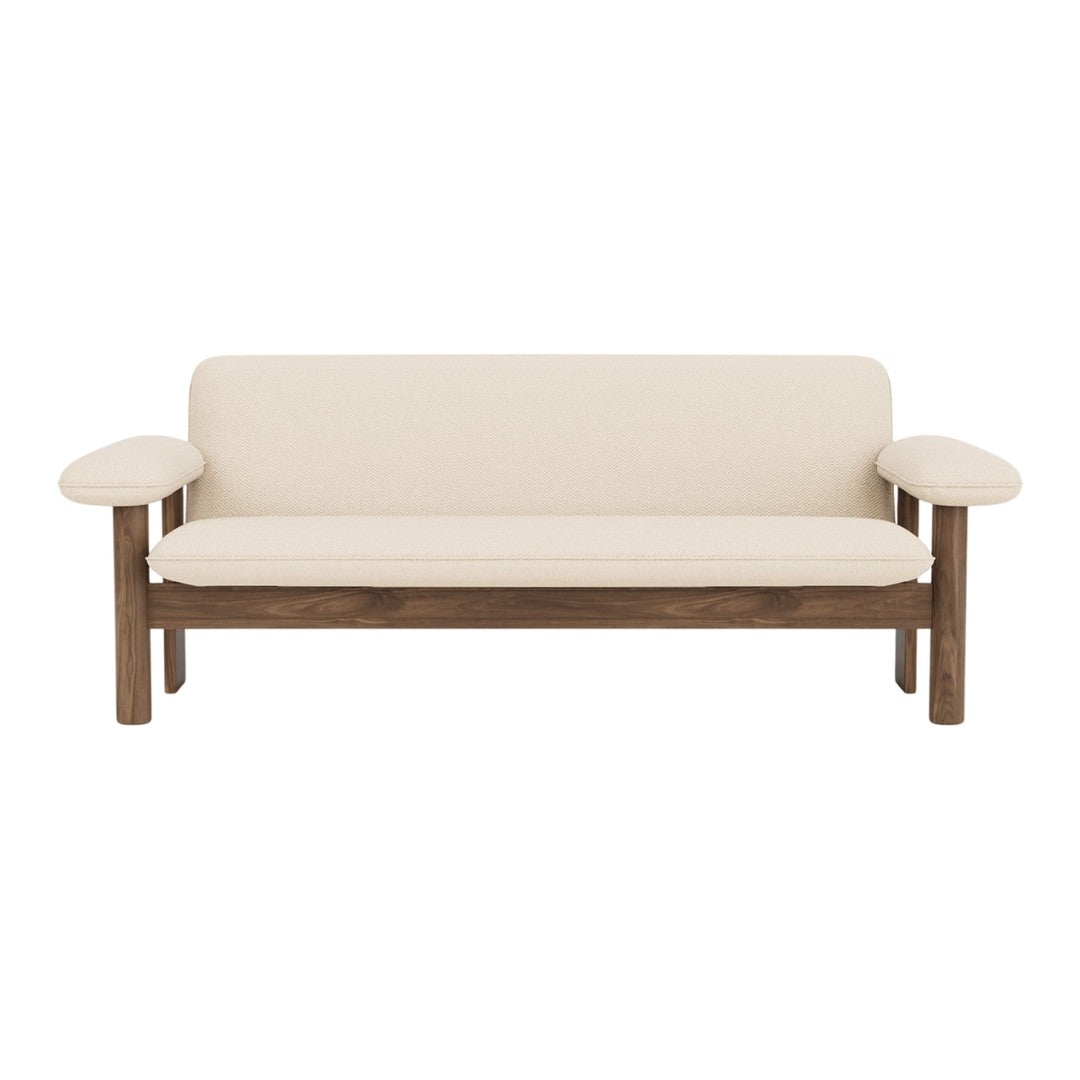 Cream upholstery sofa with a rich wood frame, featuring a minimalist design and smooth, clean lines. Perfect for modern decor.