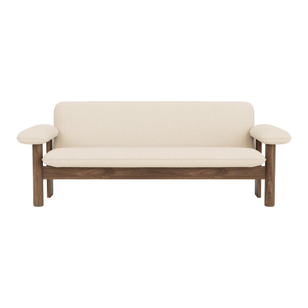 Beige upholstered sofa with wooden brown frame and smooth, minimalist design. Ideal for modern interiors.