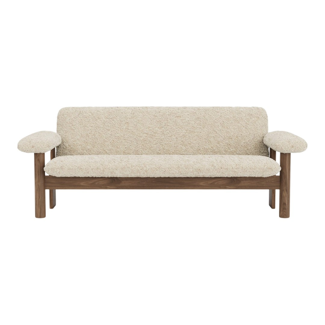 Cream textured upholstery with a subtle pattern, contrasting wooden frame in warm brown tones.