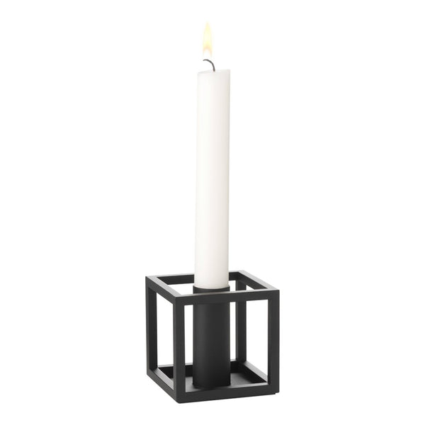 Black square candle holder with a tall white candle, minimalistic design. Ideal for modern decor.