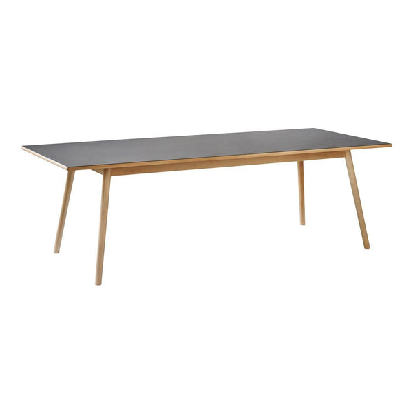 Rectangular dining table with a sleek black top and natural wood legs, featuring a clean, modern design.