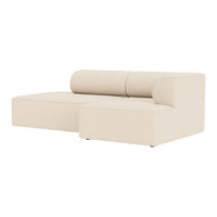 Beige sectional sofa with smooth upholstery and modern, minimalist design.