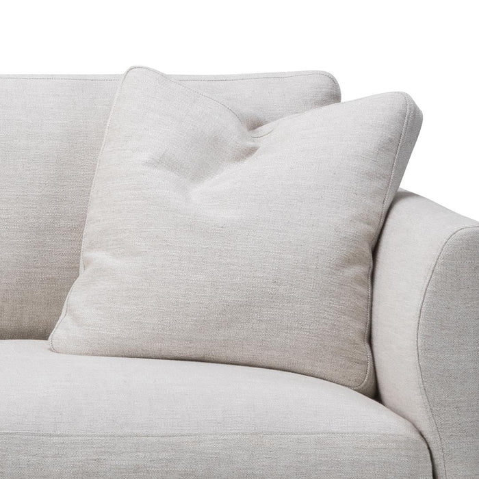Light beige sofa with a textured, subtle pattern and soft matching pillow for a cozy, modern look.