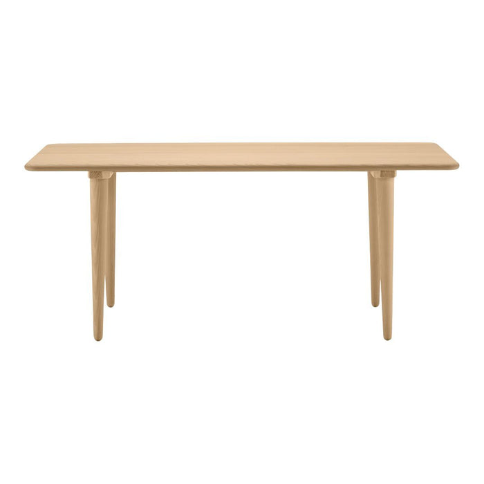 Light natural wood console table with a smooth finish and tapered legs, showcasing a minimalist design.