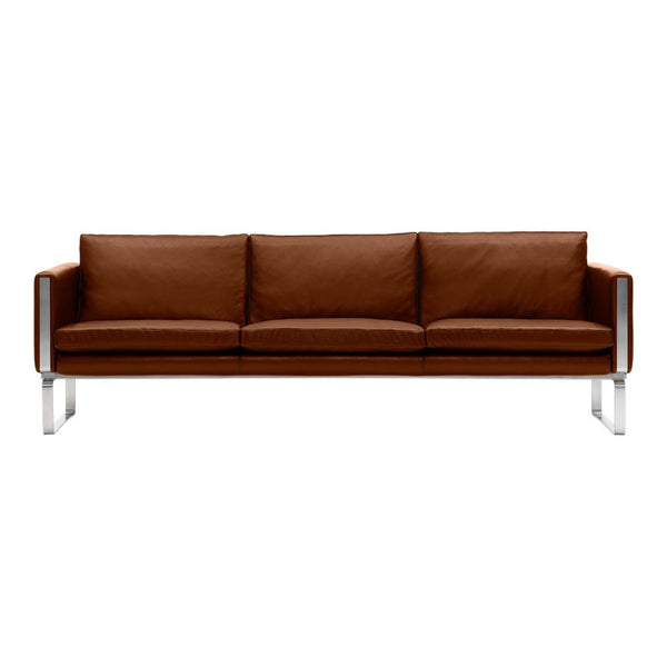 Brown leather sofa with sleek chrome legs, featuring a simple and modern design.