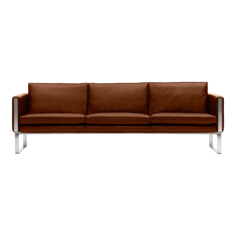 Brown leather sofa with sleek chrome legs, featuring a simple and modern design.