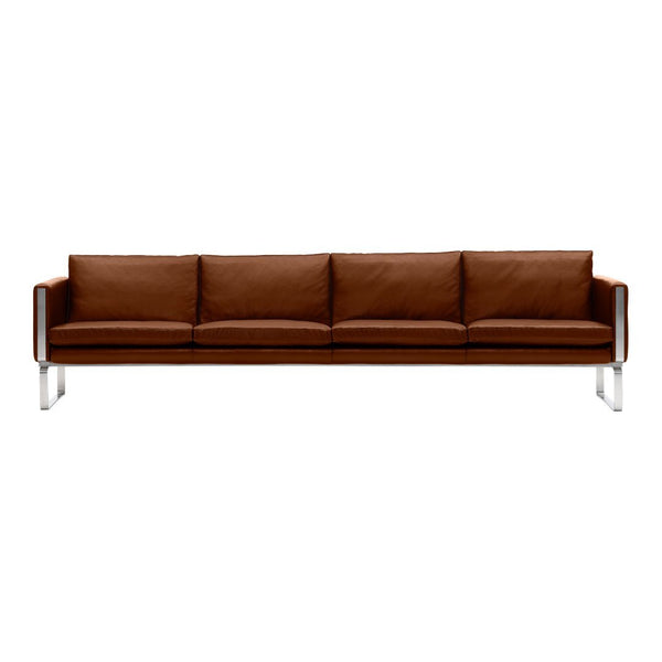 Brown leather sofa with smooth texture and modern chrome legs, featuring a sleek, minimalist design.