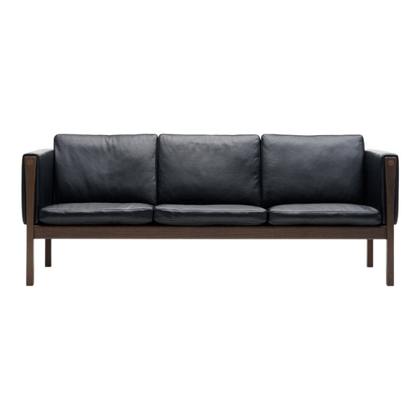 Black leather sofa with a modern wood frame, featuring a sleek and minimalist design. Ideal for contemporary decor.